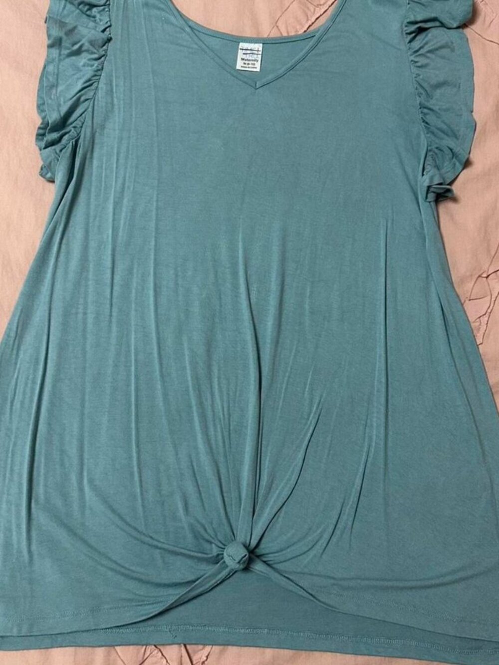 Blue maternity top with ruffle sleeves and tie detail.